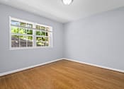 Thumbnail 3 of 15 - an empty room with hardwood floors and a large window